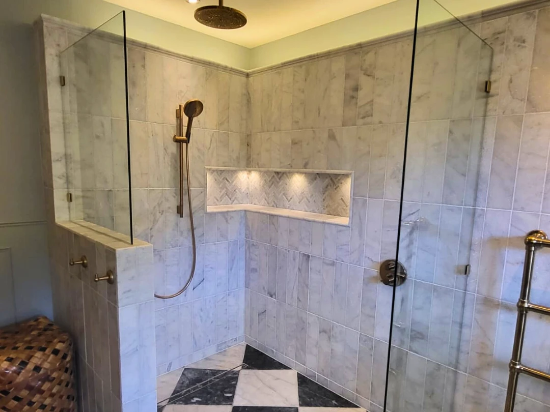 Walk-in shower and illuminated tile detailing from a Sense Renovations project